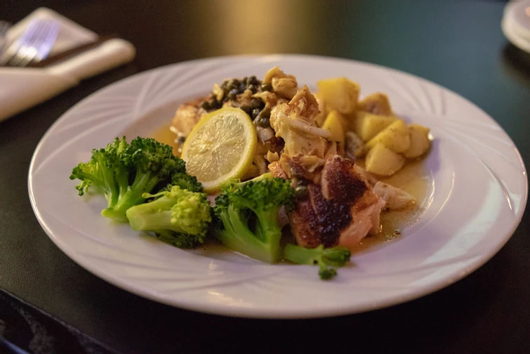plate of fish with potatos and broccoli